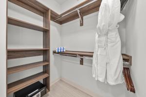 a walk in closet with wooden shelves at Level Chicago - Fulton Market in Chicago +64 photos