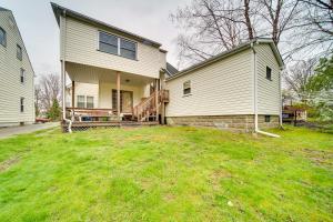 a house with a large yard in front of it at Meadville Apartment with Deck Less Than 2 Mi to Allegheny! in Meadville