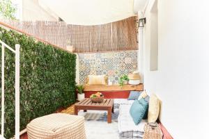 a small patio with a bench and a table at HA Diputació terrace apartment in Barcelona