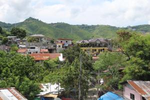 a village in the mountains with houses and trees at Large New Studio Up to 6 Pax in Cebu City