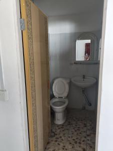 a small bathroom with a toilet and a sink at Good Luck Hostel in Phnom Penh