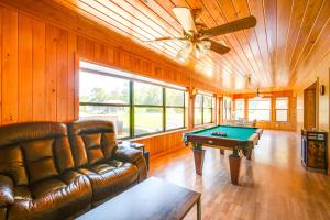 a living room with a couch and a pool table at East Palatka Vacation Rental, Anglers Paradise in East Palatka