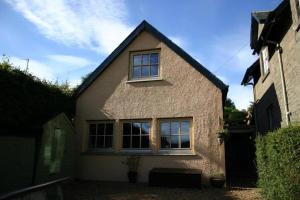 a brick house with windows on the side of it at Annexe Lodge cottage in Drymen in Drymen