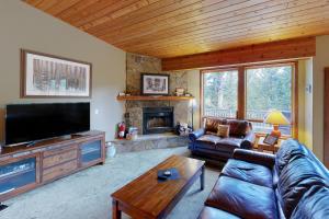 a living room with a couch and a fireplace at Hidden Village 20 in Big Sky