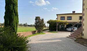 a house with a car parked next to a driveway at Pinea in Vilacolum
