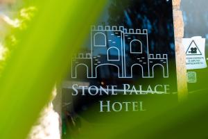 a picture of a stone palace hotel sign at Stone Palace Hotel Free Shuttle From and to Athen's Airport in Spáta