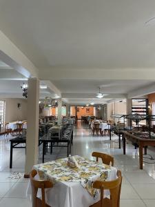 a dining room with tables and chairs in a building at HOTEL FAZENDA ROCHEDO in Conservatória