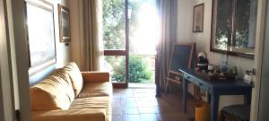 a living room with a couch and a large window at Relais La Canfora in Rome