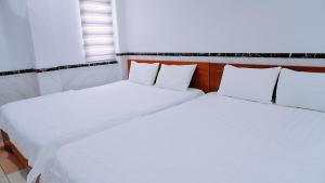 Postel nebo postele na pokoji v ubytování Hoài Thu Hotel Vũng Tàu