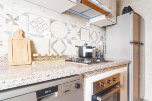 a kitchen with a counter top with a pot on a stove at Magnifique Appartement Golf Tanger for Families in Tangier