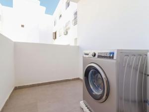 a washing machine in a room with a building at Magnifique Appartement Golf Tanger for Families in Tangier