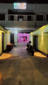 a motorcycle parked in a parking garage at night at Hotel The Aparna Residency in Āsansol