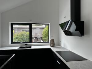 a kitchen with a sink and a window at Tromsø central guest house with parking in Tromsø