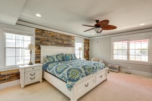 a bedroom with a bed and a ceiling fan at Waterfront Ocean City Escape with Large Deck, Pool! in Ocean City
