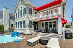 a house with a swimming pool in front of a house at Waterfront Ocean City Escape with Large Deck, Pool! in Ocean City