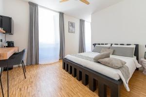 a bedroom with a bed and a desk and a table at cavaedium guest house in Arona