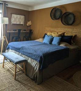 a bedroom with a bed and a table and chairs at Landhaus Spanier in Nonnweiler