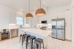 a kitchen with a large white counter and stools at New Luxury Villa and Private Pool-Cart-Ocean View! in Port Aransas