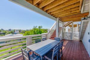 a porch with a wooden table and chairs at New Luxury Villa and Private Pool-Cart-Ocean View! in Port Aransas