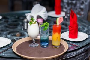 a table topped with plates and glasses of drinks at Noble House Hotel in Kumasi