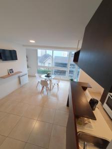 een keuken en een woonkamer met een tafel en stoelen bij La Perla Moderno 2 Amb a 100 mts del Mar in Mar del Plata