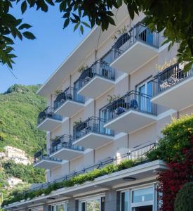 a tall building with balconies and plants on it at Hotel Elisabetta in Castellammare di Stabia