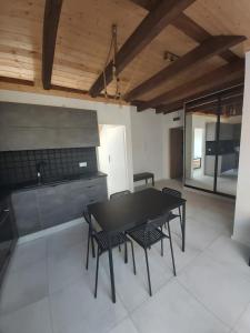 a dining room with a black table and chairs at Apartamenty Łagiewniki in Krakow