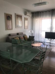 a living room with a glass table and a couch at ANTIBES très belle situation ! in Antibes