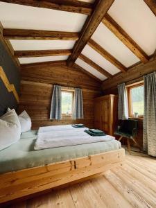 a bedroom with a bed in a wooden house at Chalet BRUNNHÄUSL in Hüttschlag