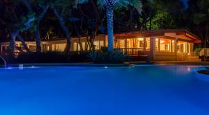a house with a swimming pool at night at Largo Resort in Key Largo