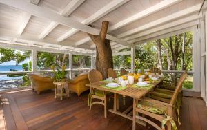 a dining room with a table and a tree at Largo Resort in Key Largo
