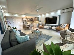 a living room with a couch and a tv in it at Beachfront Villa in the Rio Mar Resort in Rio Grande