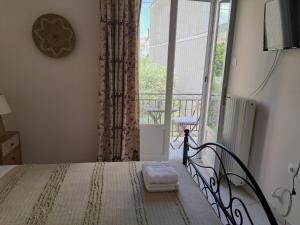 a bedroom with a bed and a large window at Penny's Beach Cottage in Galaxidi