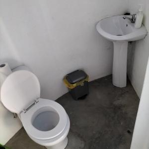 a bathroom with a toilet and a sink at Pensao Zé Doce in Portela