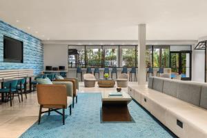 a lobby of a hotel with a waiting room at Delta Hotels by Marriott Orlando Celebration in Orlando