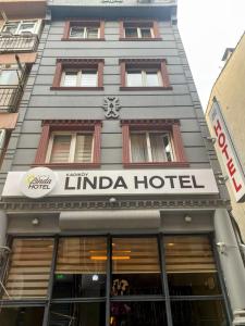 a building with a hotel sign in front of it at Kadıköy Linda Hotel in Istanbul