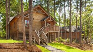 a log cabin in the woods with a staircase at Shenandoah Wilderness Traveler in Gordonsville