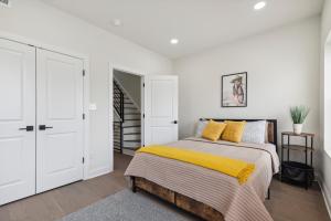 a bedroom with a bed with a yellow blanket at Modern City living in Philadelphia