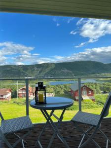 a table and two chairs on a porch with a view at Geilo in Geilo