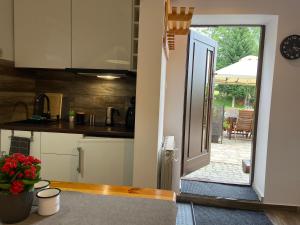 a kitchen with a door open to a patio at Cerla Korbielów in Korbielów +90 photos