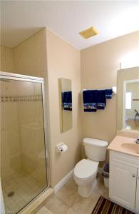 a bathroom with a shower and a toilet and a sink at Water Views & Community Pool - Condo Casa Marbella - Roelens Vacations in Cape Coral