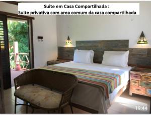 a bedroom with a bed and a chair and a window at Casa Verde Apart - Aptos e Casa Residencial in Praia do Forte