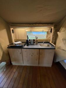 a kitchen with a sink in a tent at Safari Tent M in Berdorf