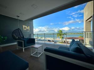 a living room with a blue couch and a view of the ocean at DM HOTEL in Propriá