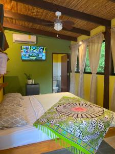 Schlafzimmer mit einem Bett und einem Deckenventilator in der Unterkunft Las Plumas de Cabuya in Cabuya