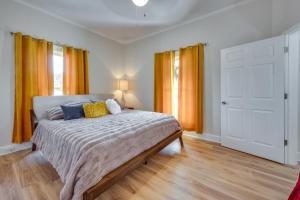 1 dormitorio con 1 cama con cortinas amarillas en Albemarle Home Rental Near Shopping and Dining!, en Albemarle