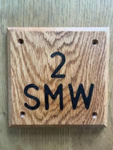 a wooden block with the word samwx on it at 2 smw in Peebles