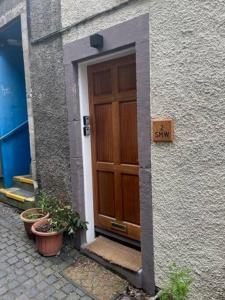 a wooden door on a building with a sign on it at 2 smw in Peebles