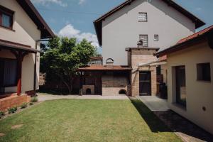 an exterior view of a house with a yard at Apartments Peric - Županja in Županja