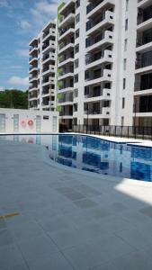 a swimming pool in front of a large apartment building at Alojamiento Ricaurte Piso 6 in Ricaurte